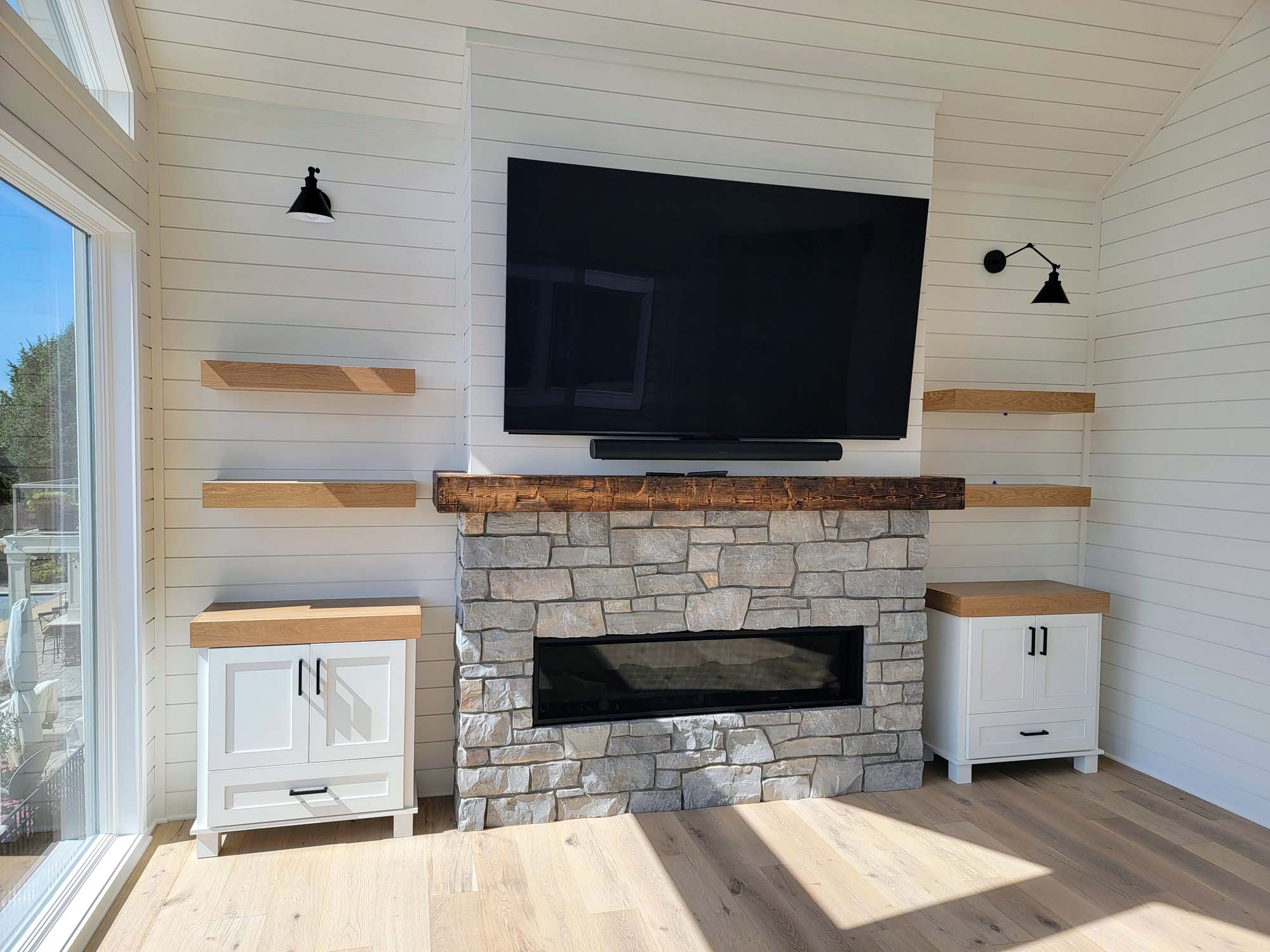Media wall with TV, fireplace, shelves and custom cabinets