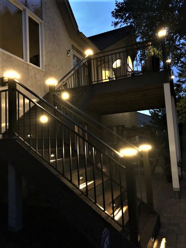 Staircase LED lights corner post and tread riser at night