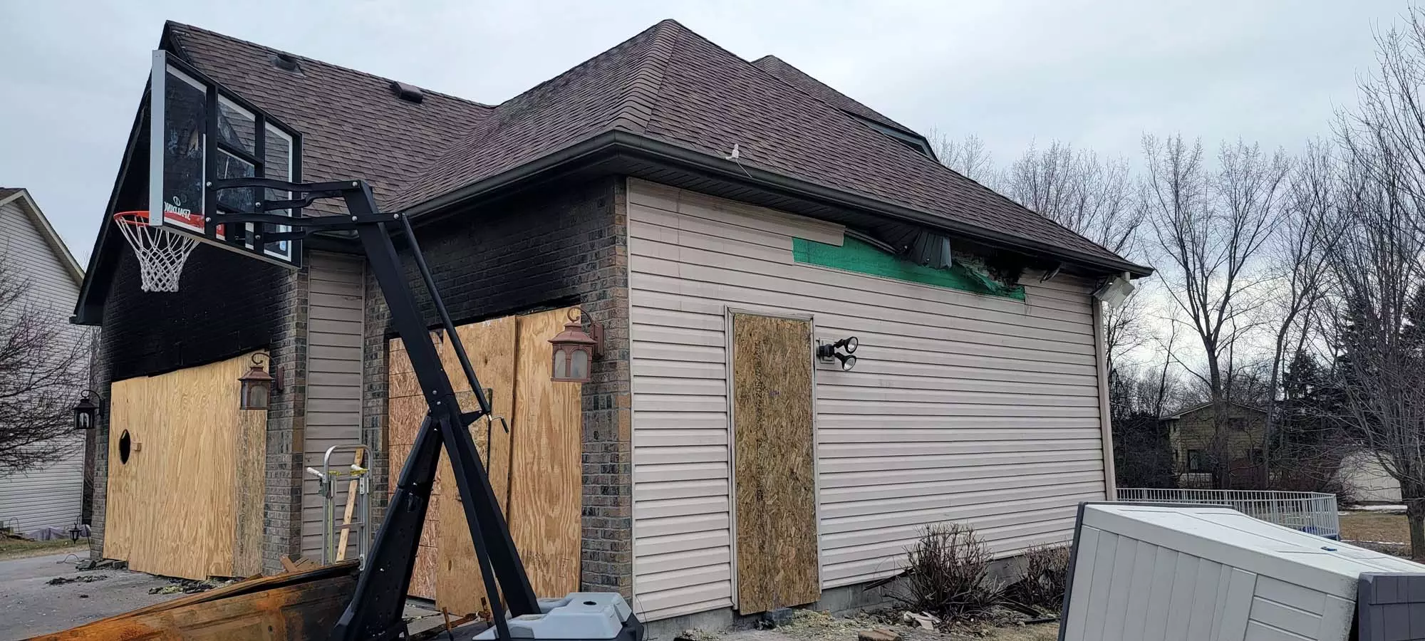Fire damaged garage exterior soffit and siding damage