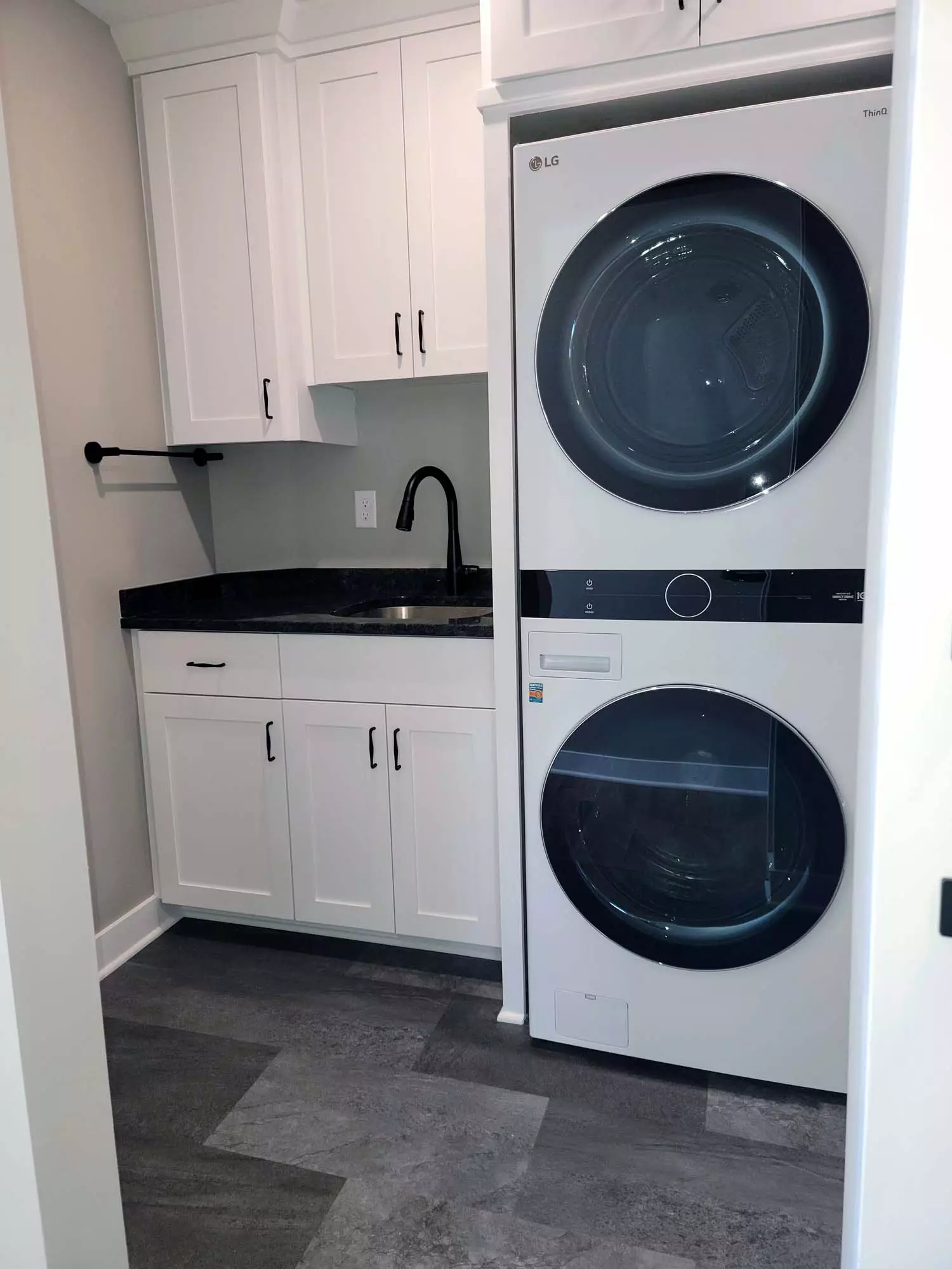 Upgraded laundry room with space saving stackable washer & dryer