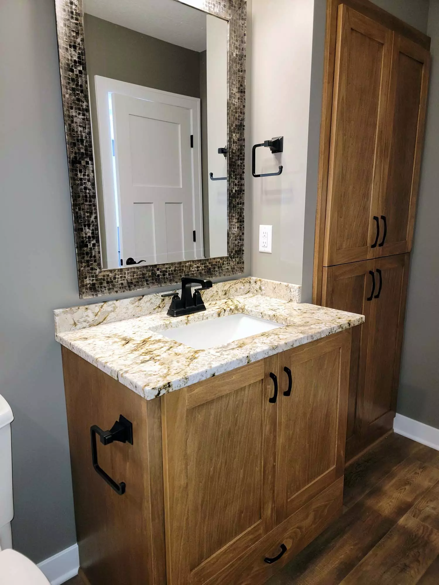 Rustic finish vanity and linen cabinetry