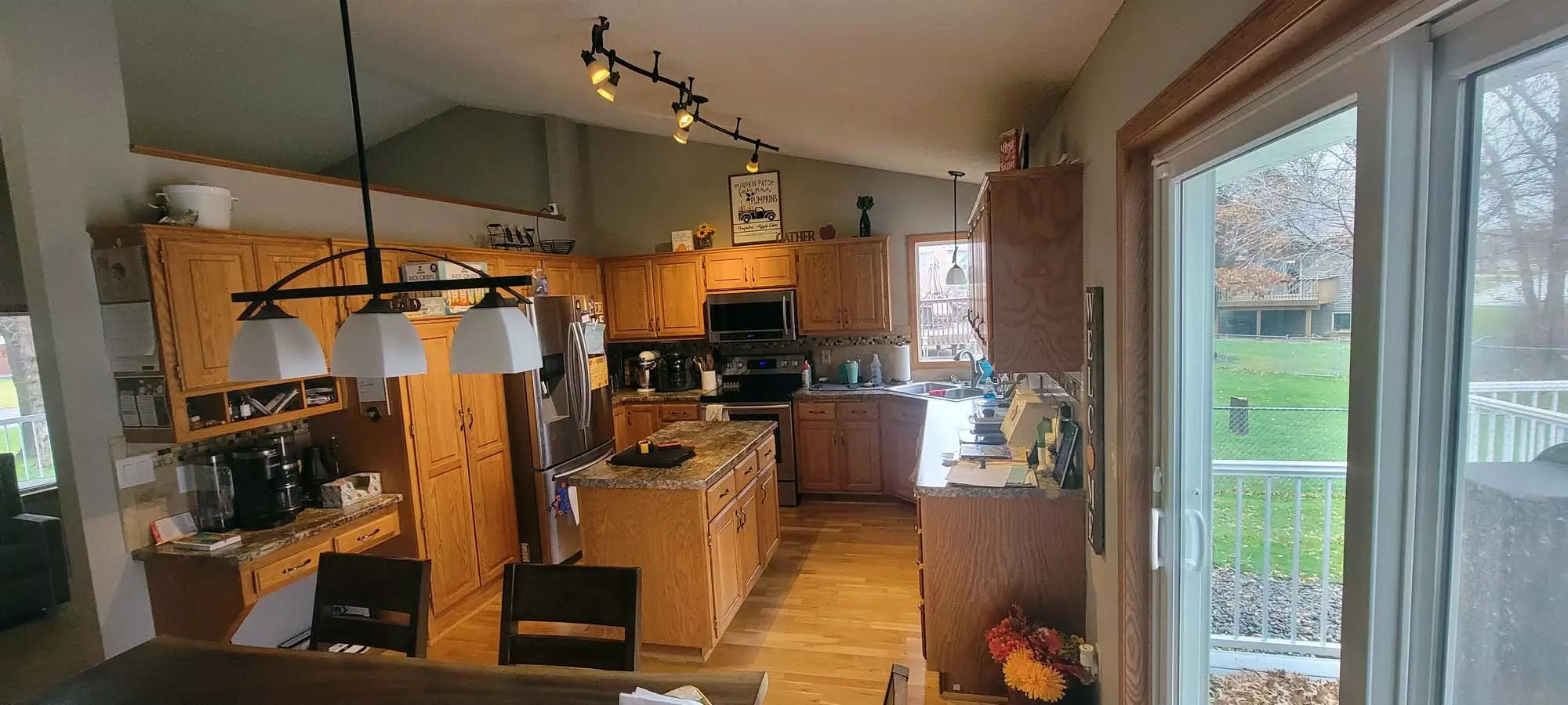 Andover Home camped kitchen with small island before remodel to create large Kitchen w/ Walk-In-Pantry
