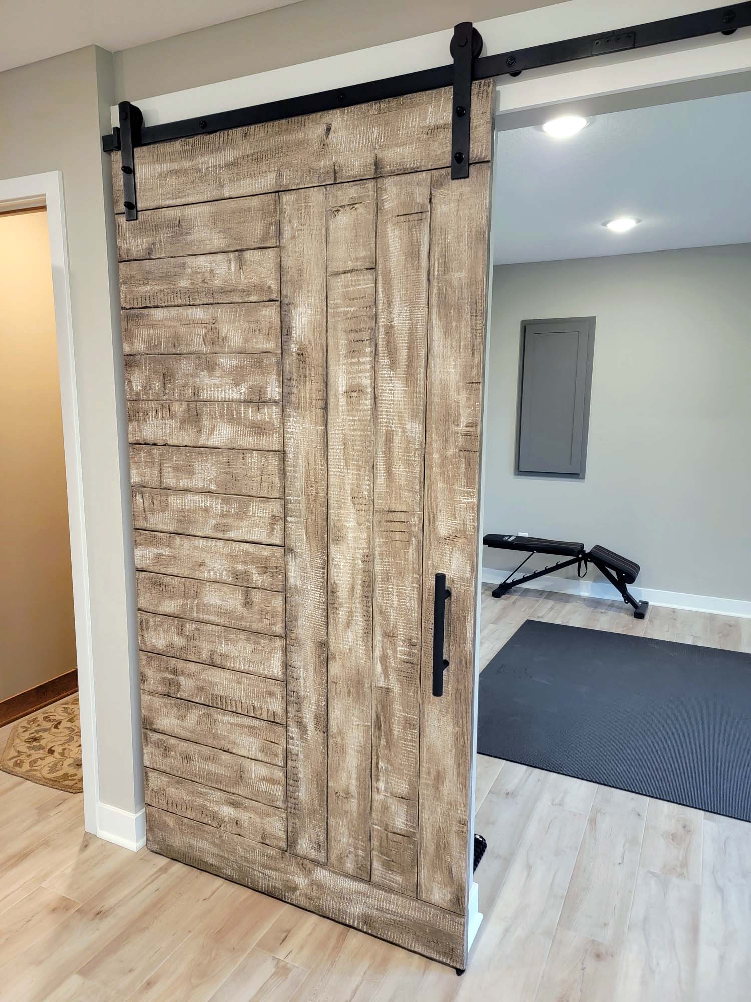Left side barn track door to exercise room