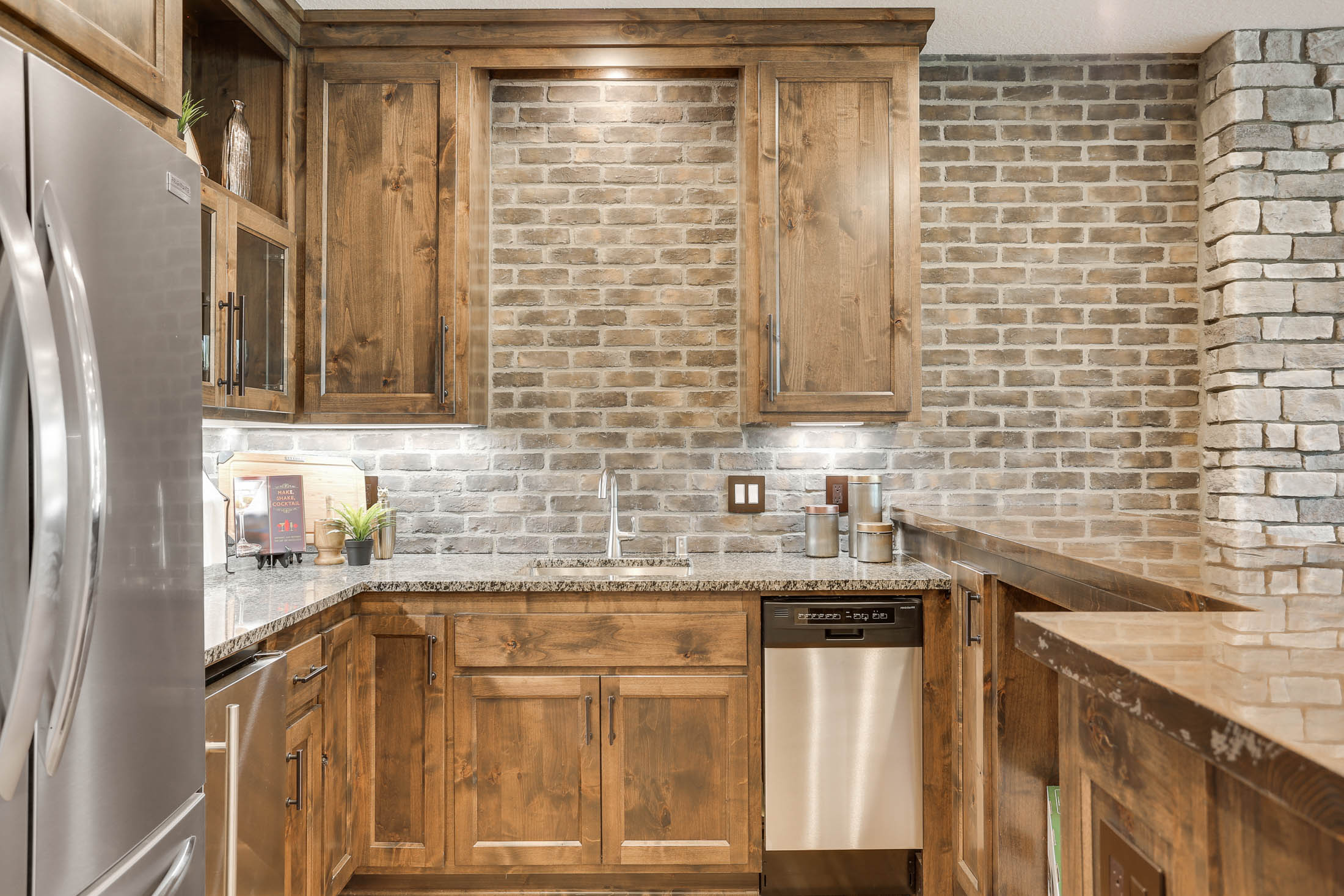 Brick and stone walls and custom rustic wood cabinets