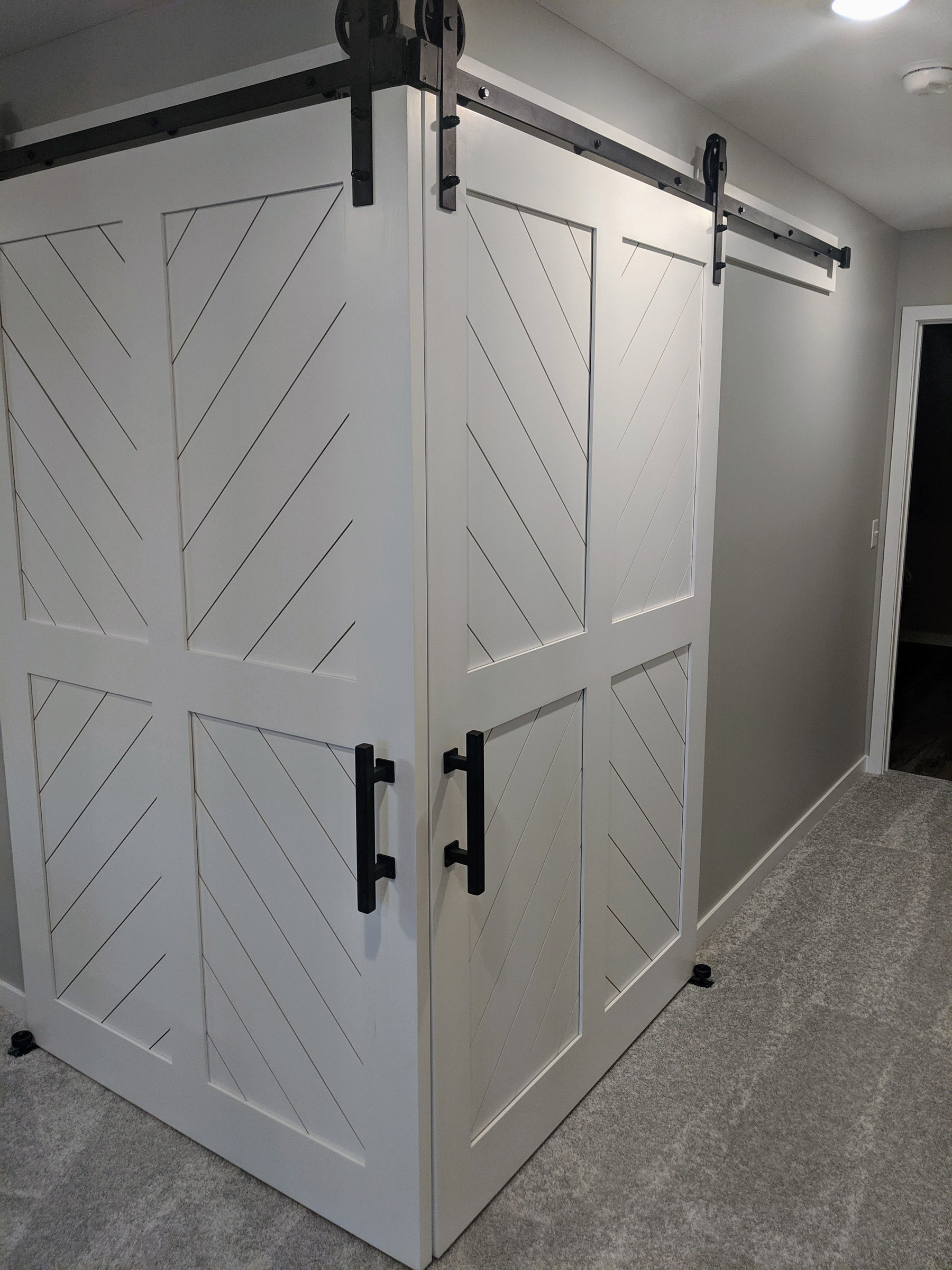 A set of Corner 5’ x 7’ Custom track doors, open the space to the guest bedroom