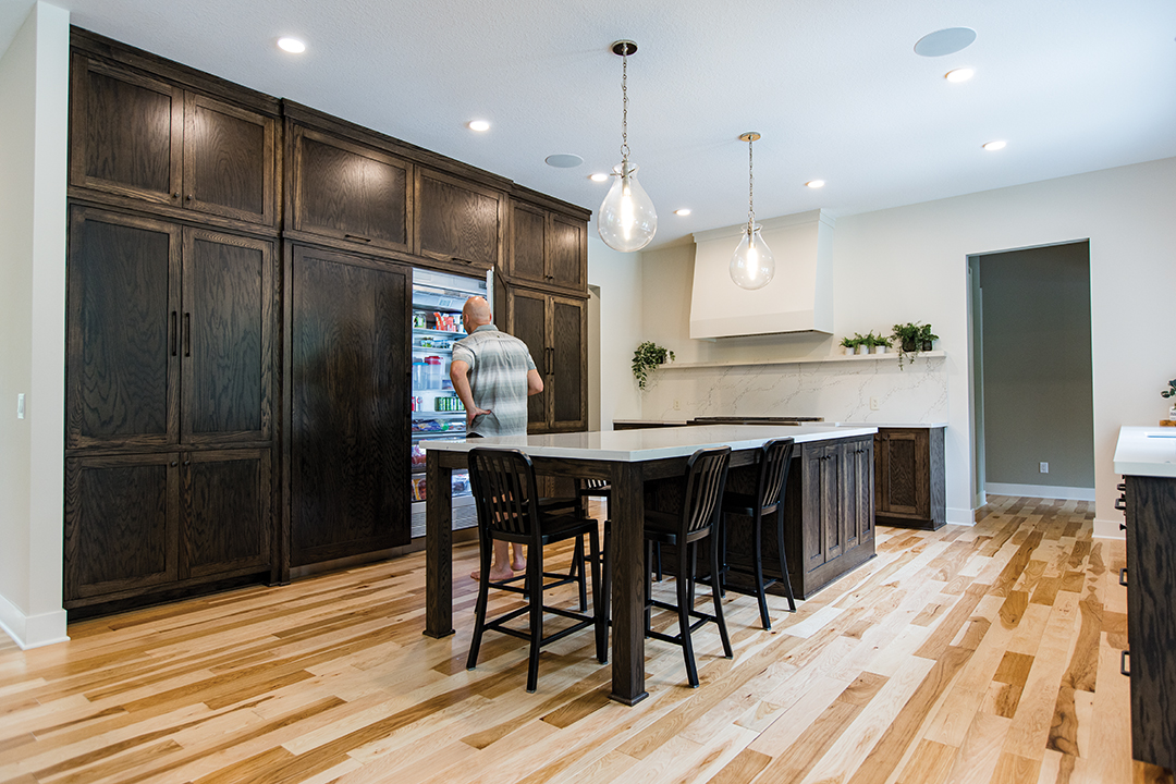 Kitchen features an oversized island and paneled appliances