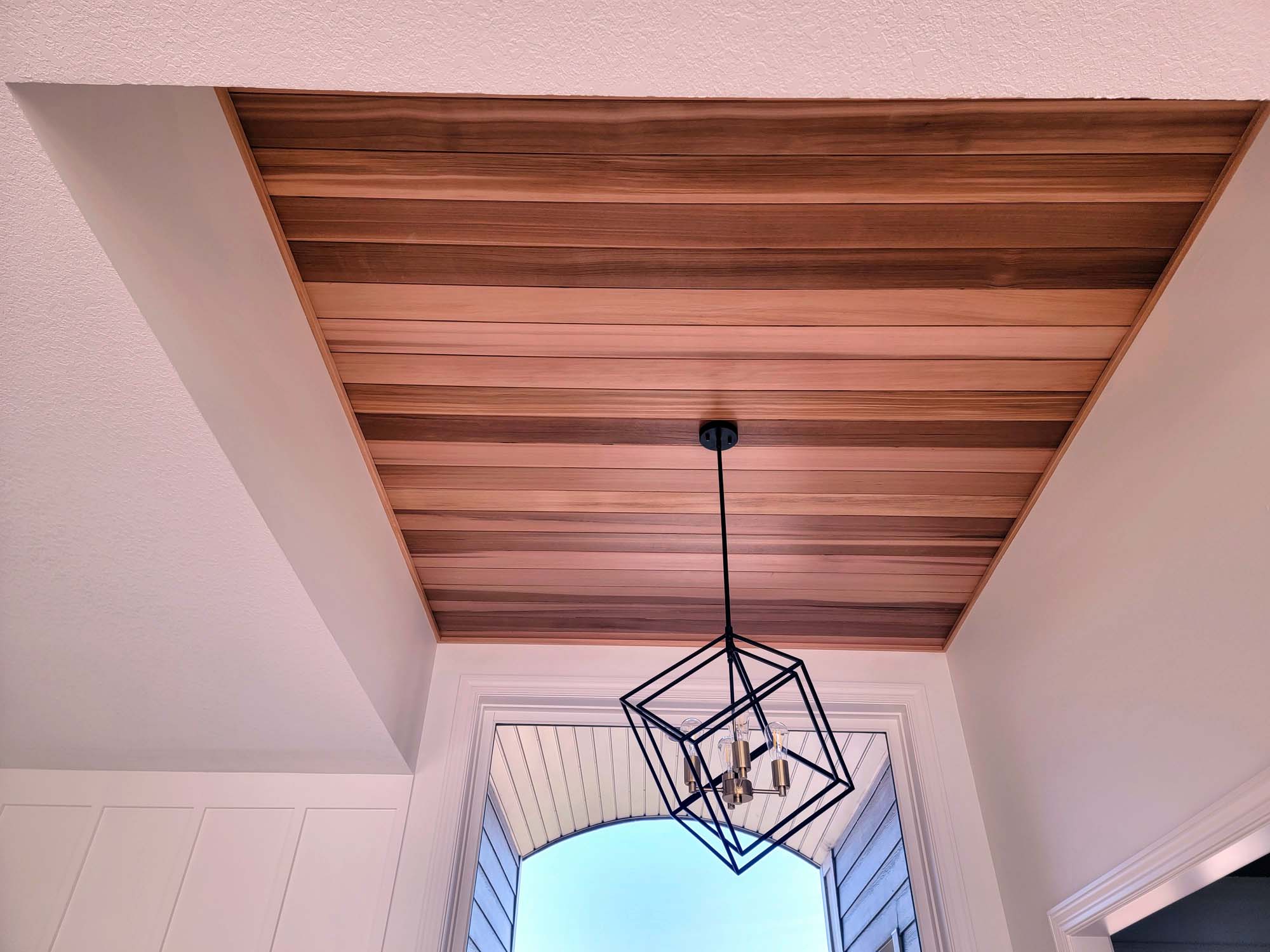 Foyer wood ceiling with modern light fixture